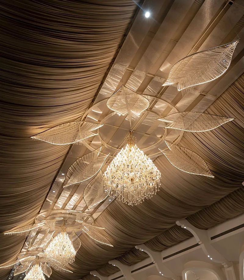 Crystal chandeliers hanging from the draped ceiling of the hall